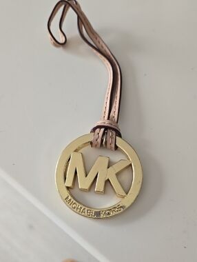 Michael Kors Gold MK Logo Pendant Beige With Gold Hardware.